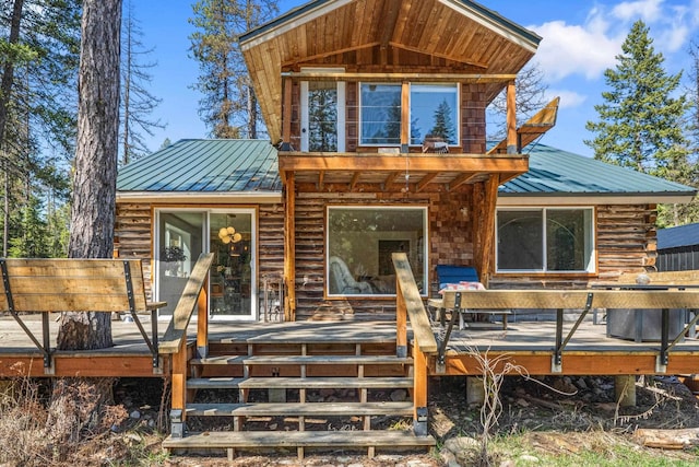 4167 Grouse Creek Rd, Loon Lake, WA 99148 - view of front facade featuring log exterior, a deck, metal roof, and a standing seam roof