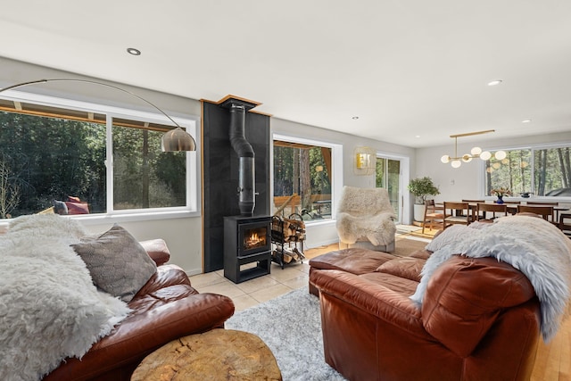 4167 Grouse Creek Rd, Loon Lake, WA 99148 - living area featuring light tile patterned floors, baseboards, recessed lighting, and a wood stove