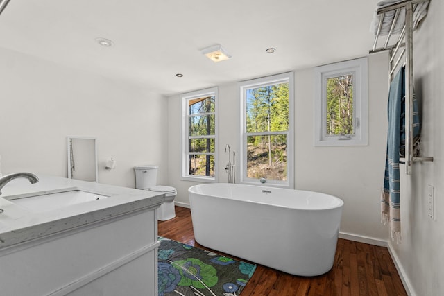 4167 Grouse Creek Rd, Loon Lake, WA 99148 - full bath featuring a freestanding bath, wood finished floors, vanity, and baseboards