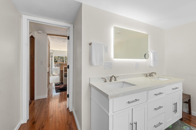 4167 Grouse Creek Rd, Loon Lake, WA 99148 - bathroom with a sink, double vanity, and wood finished floors