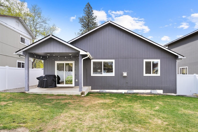 back of house with a yard, a patio area, and a fenced backyard