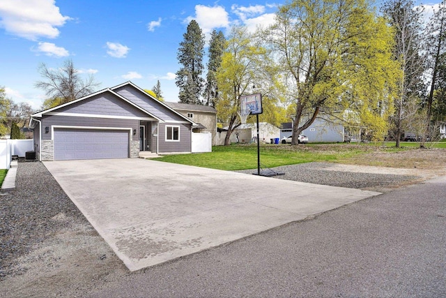 view of front of property with a garage, stone siding, a front lawn, and concrete driveway