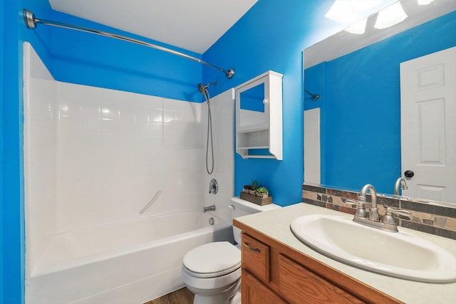 bathroom with toilet, tub / shower combination, and vanity