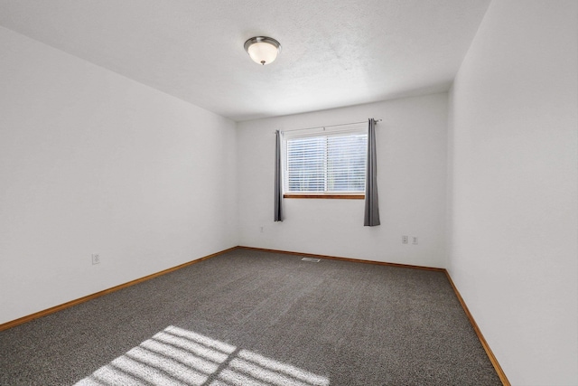 unfurnished room featuring baseboards and carpet flooring