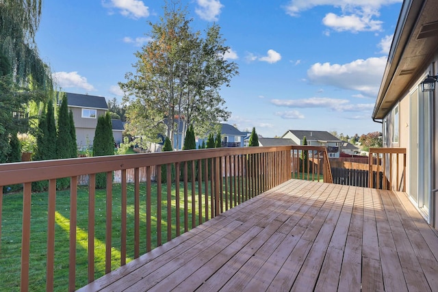 deck with a yard and a residential view