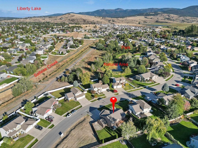 birds eye view of property featuring a mountain view and a residential view