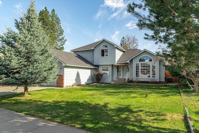 5905 W Excell Ave, Spokane, WA 99208 - traditional-style home with a shingled roof, an attached garage, central air condition unit, and a front lawn