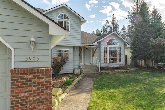 5905 W Excell Ave, Spokane, WA 99208 - view of front of house with a front yard and roof with shingles
