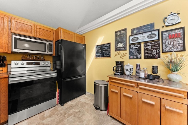 5905 W Excell Ave, Spokane, WA 99208 - kitchen featuring light countertops, brown cabinetry, and appliances with stainless steel finishes