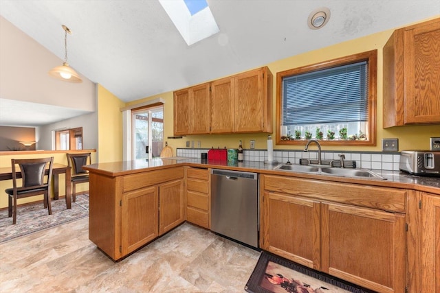 5905 W Excell Ave, Spokane, WA 99208 - kitchen featuring vaulted ceiling with skylight, decorative light fixtures, dishwasher, a sink, and a peninsula