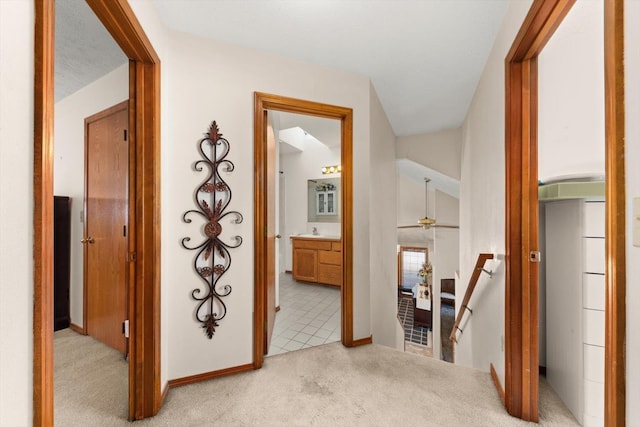 5905 W Excell Ave, Spokane, WA 99208 - hall featuring baseboards, an upstairs landing, light colored carpet, and a sink