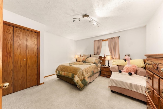 5905 W Excell Ave, Spokane, WA 99208 - bedroom with a textured ceiling, light colored carpet, and rail lighting
