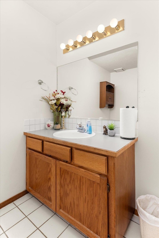 5905 W Excell Ave, Spokane, WA 99208 - bathroom with tile patterned flooring, vanity, and baseboards