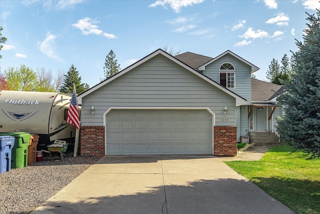 5905 W Excell Ave, Spokane, WA 99208 - view of front facade with roof with shingles, brick siding, driveway, and an attached garage