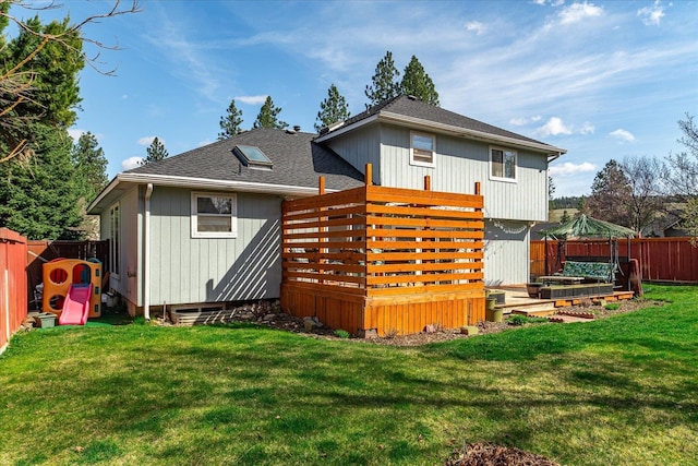 5905 W Excell Ave, Spokane, WA 99208 - back of house with a yard, a fenced backyard, a wooden deck, and roof with shingles