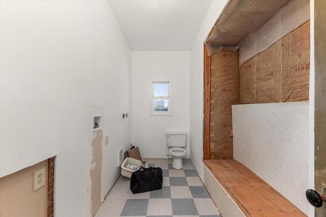 bathroom with toilet and tile patterned floors