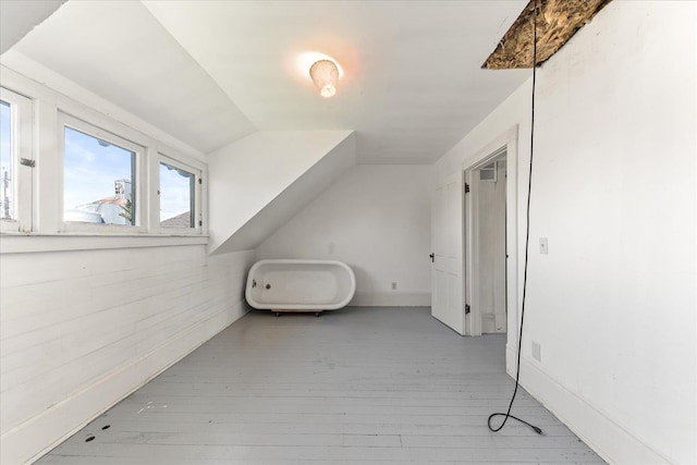 bonus room featuring wood finished floors and lofted ceiling