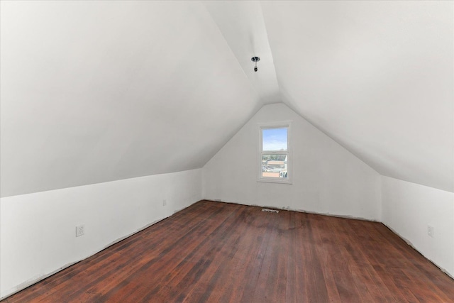 bonus room with wood finished floors and vaulted ceiling