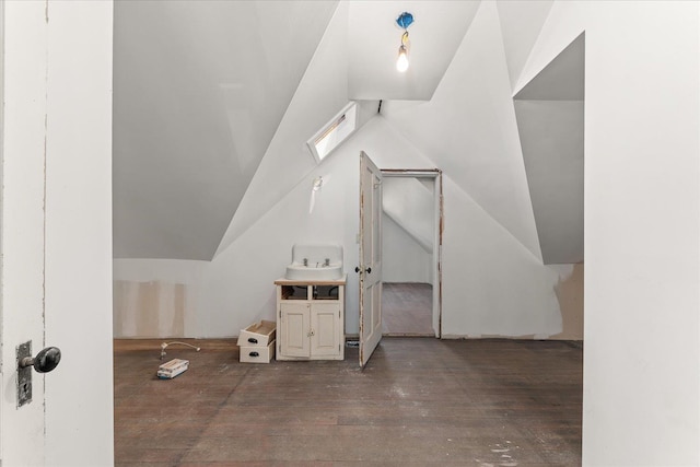 additional living space with hardwood / wood-style floors and lofted ceiling