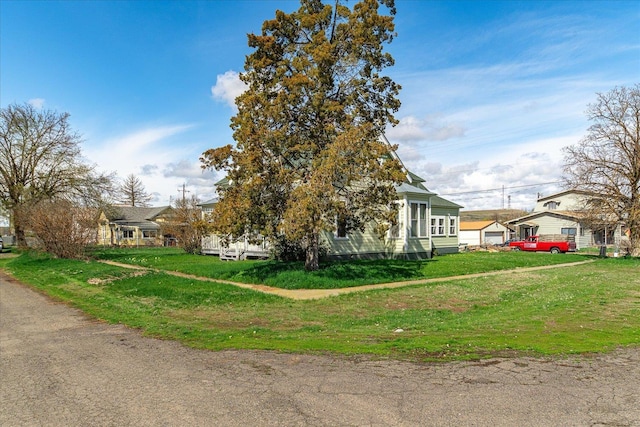 view of property exterior with a garage and a lawn