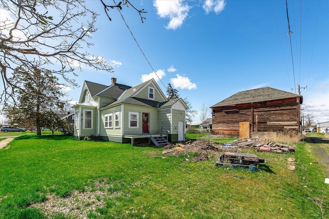 back of property with a lawn