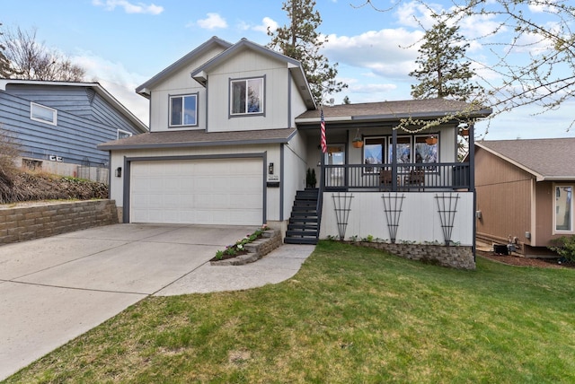 split level home featuring an attached garage, covered porch, concrete driveway, stairs, and a front lawn
