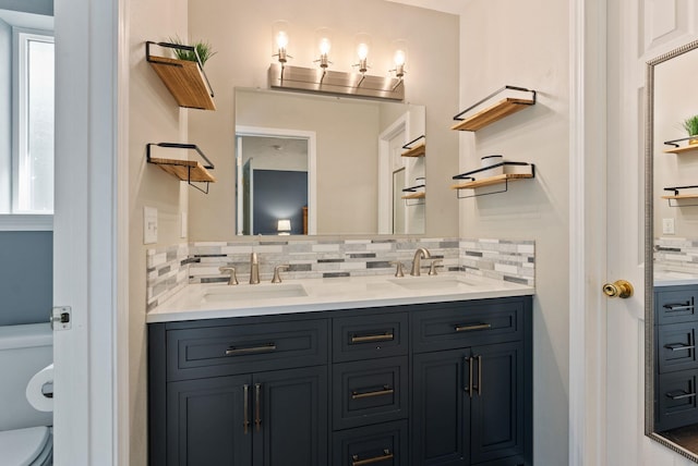 full bathroom with tasteful backsplash and a sink