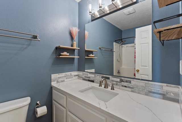 full bath featuring toilet, a shower, and vanity