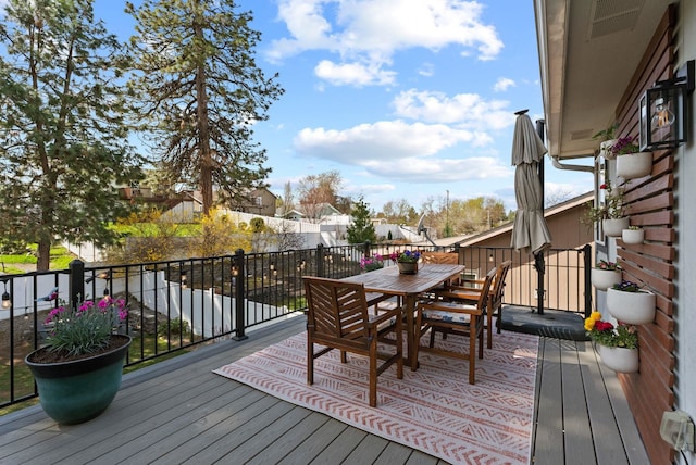 wooden terrace with outdoor dining space