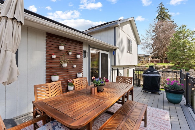 wooden deck featuring outdoor dining area