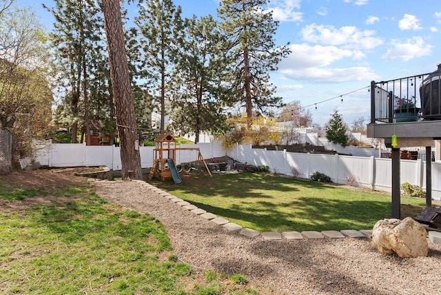 view of yard featuring a fenced backyard and a playground