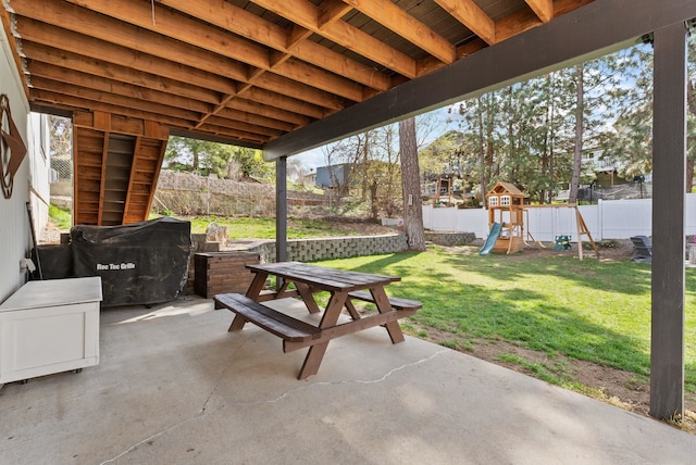 view of patio / terrace with a fenced backyard and a playground