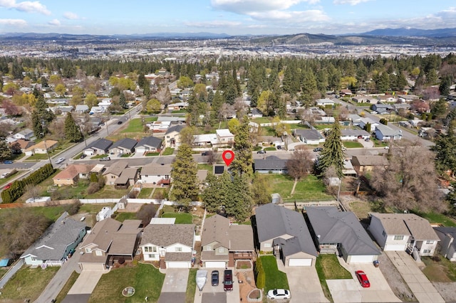 drone / aerial view featuring a residential view and a mountain view