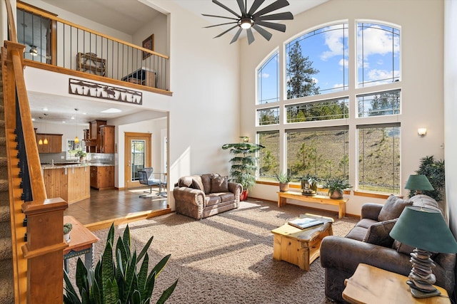 living room featuring stairway and a high ceiling