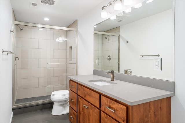 bathroom with vanity, recessed lighting, toilet, a shower stall, and visible vents
