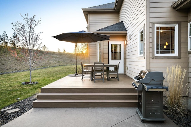wooden deck with area for grilling, a yard, and outdoor dining area