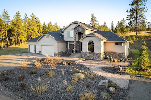 view of front of house featuring concrete driveway, a garage, and stone siding