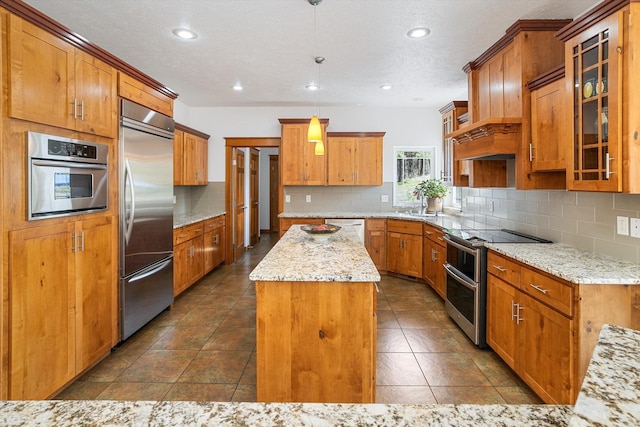 kitchen featuring decorative backsplash, appliances with stainless steel finishes, a kitchen island, and recessed lighting