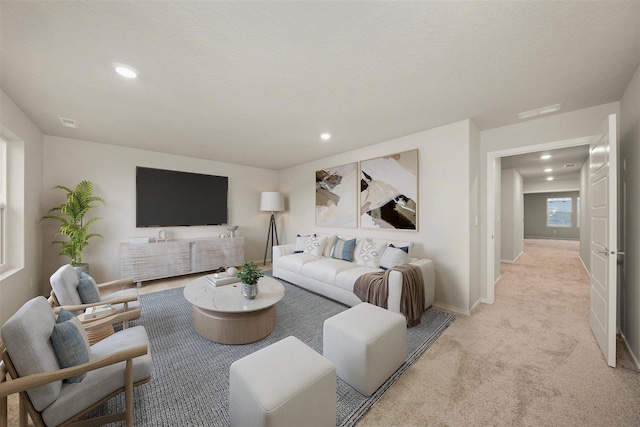 living room with light colored carpet, baseboards, visible vents, and recessed lighting