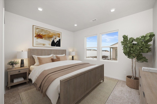 bedroom with visible vents, baseboards, recessed lighting, and light carpet