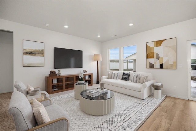 living room with recessed lighting, light wood-style floors, and baseboards