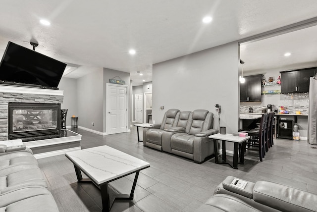 12808 N N Park St, Newman Lake, WA 99025 - living room featuring recessed lighting, wood finished floors, and a stone fireplace