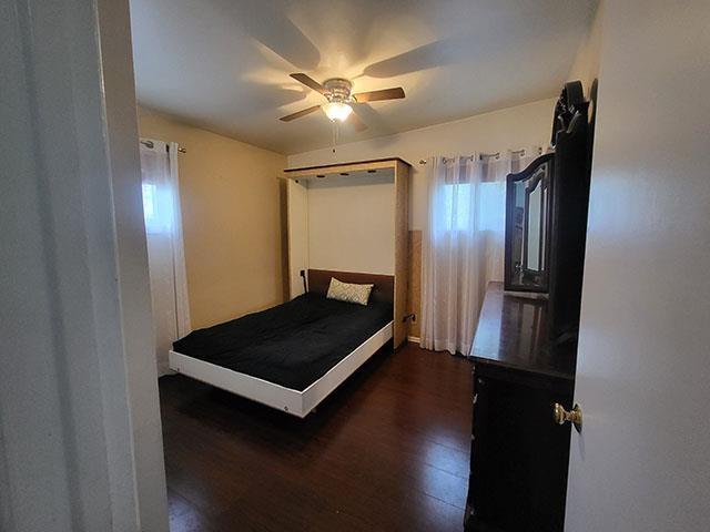 bedroom featuring wood finished floors and ceiling fan