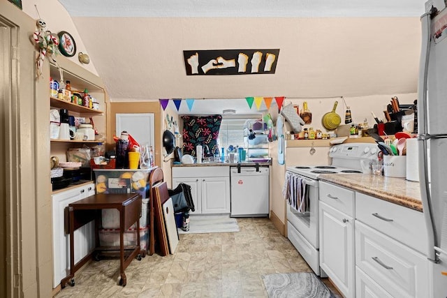 723 W Montgomery Ave, Spokane, WA 99205 - kitchen featuring white appliances, white cabinetry, open shelves, light stone counters, and vaulted ceiling