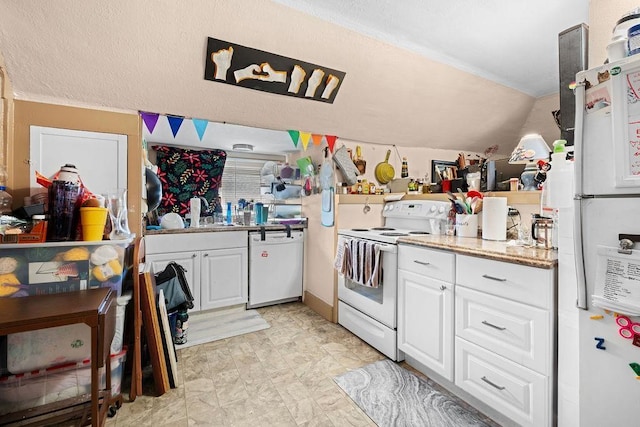 723 W Montgomery Ave, Spokane, WA 99205 - kitchen with white appliances, white cabinetry, lofted ceiling, and light stone countertops