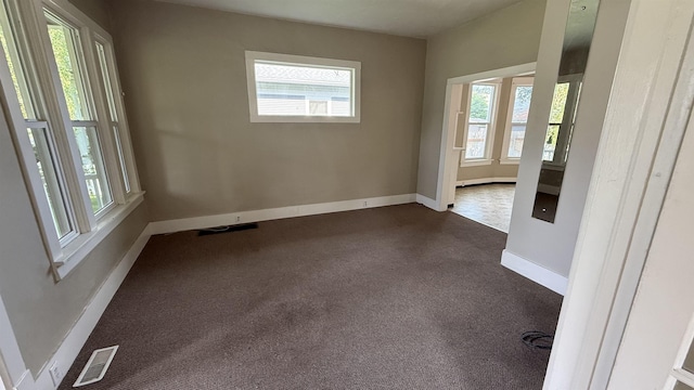 723 W Montgomery Ave, Spokane, WA 99205 - unfurnished room featuring healthy amount of natural light and dark colored carpet