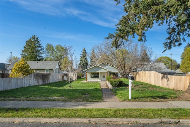 bungalow-style home featuring a fenced front yard and a front yard