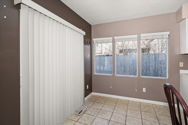 interior space with visible vents, baseboards, and light tile patterned floors