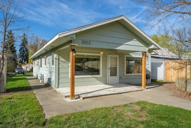 exterior space with a patio area, a front yard, and fence