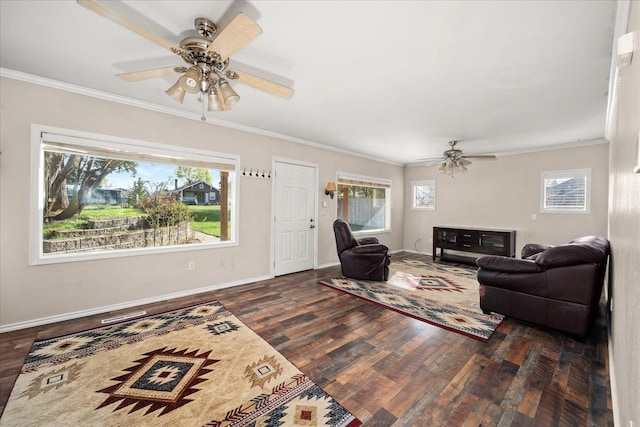 living area with baseboards, wood finished floors, ornamental molding, and ceiling fan